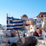 The flag of Greece – Houses of Oia as backdrop