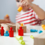 Child,Plays,With,Developmental,Toy.,Boy,Plays,With,Wooden,Cylinders